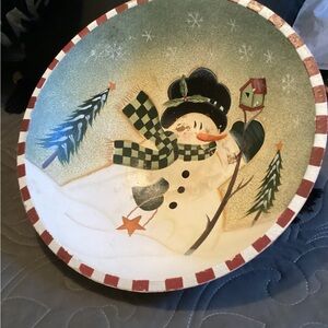 Vintage wooden bowl with a winter scene, a snowman holding a birdhouse